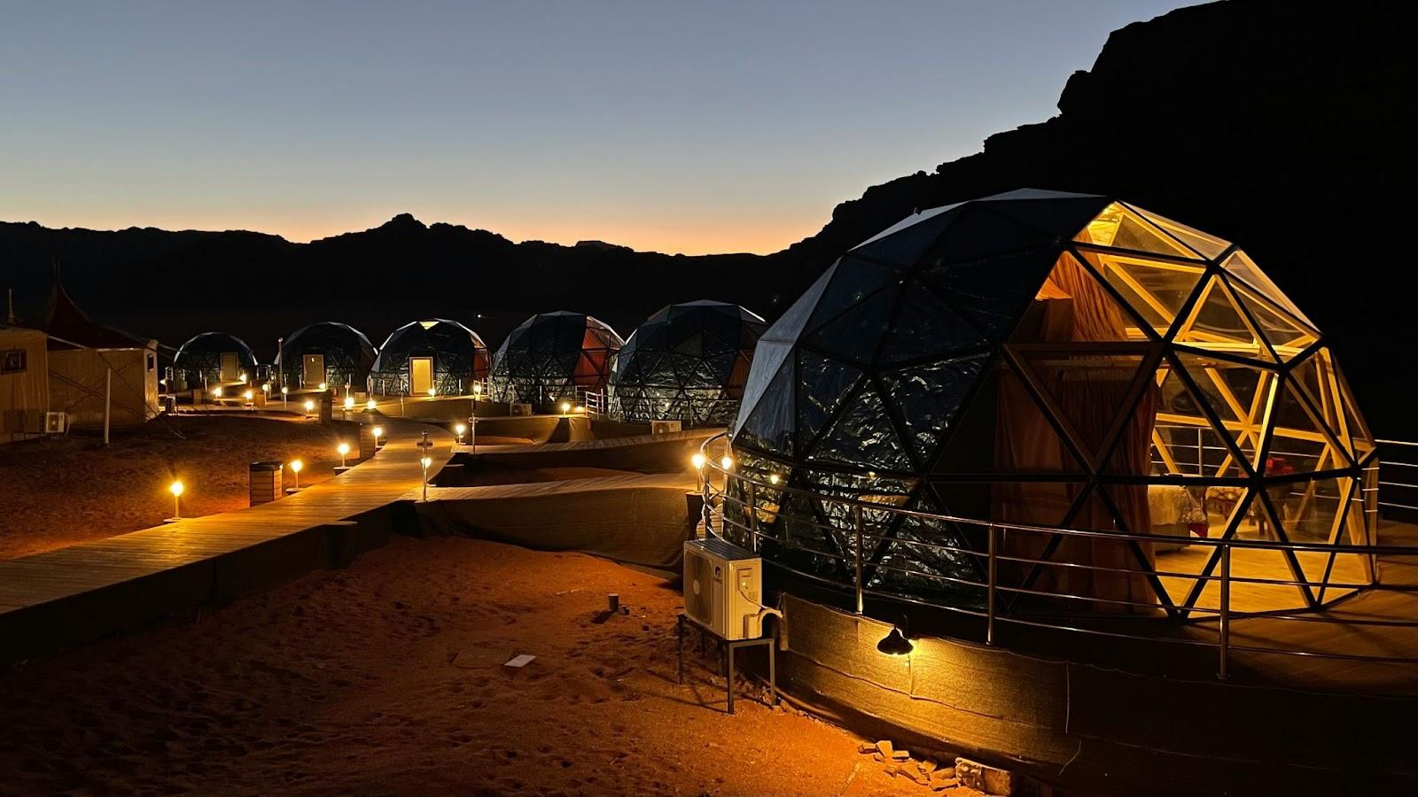 a group of desert domes lit up at night, Wadi Run Jordan