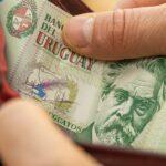Uruguayan money. hands opening wallet with Uruguayan peso