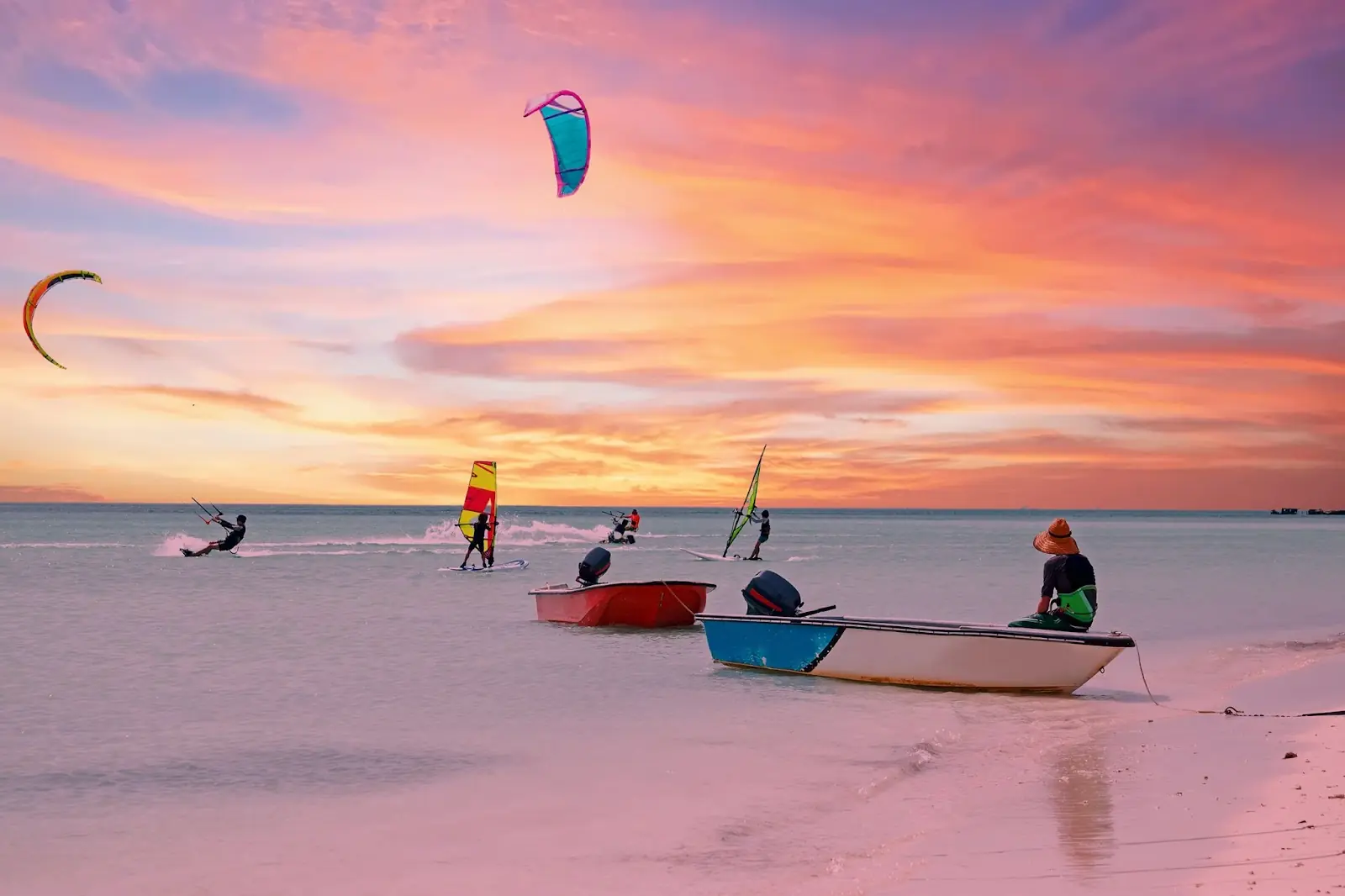 Watersports at Palm Beach on Aruba island in the Caribbean Sea at sunset.