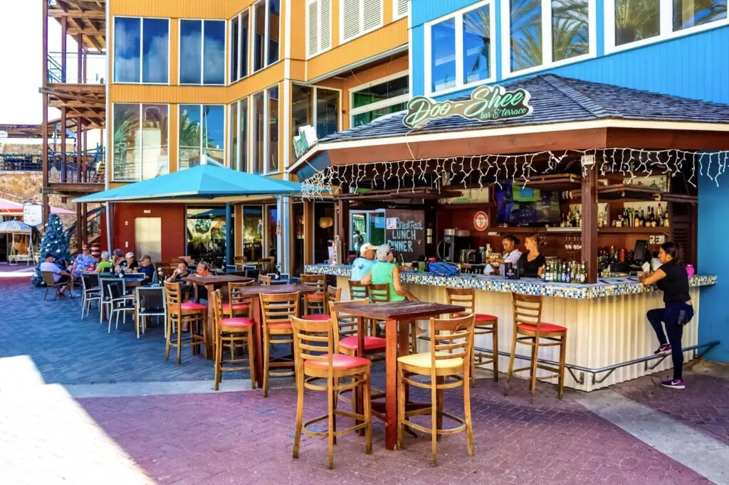 View of outdoor cafe with clients at some of tables. Tourism. Willemstad. Curacao.