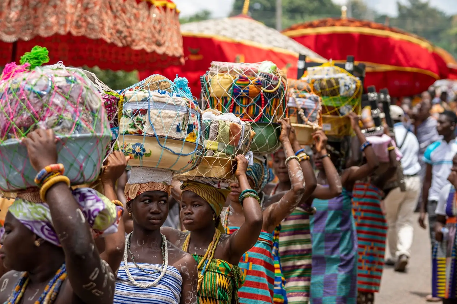 women's procession carry gifts on their heads for the Paramount Chief during a Yam Festival