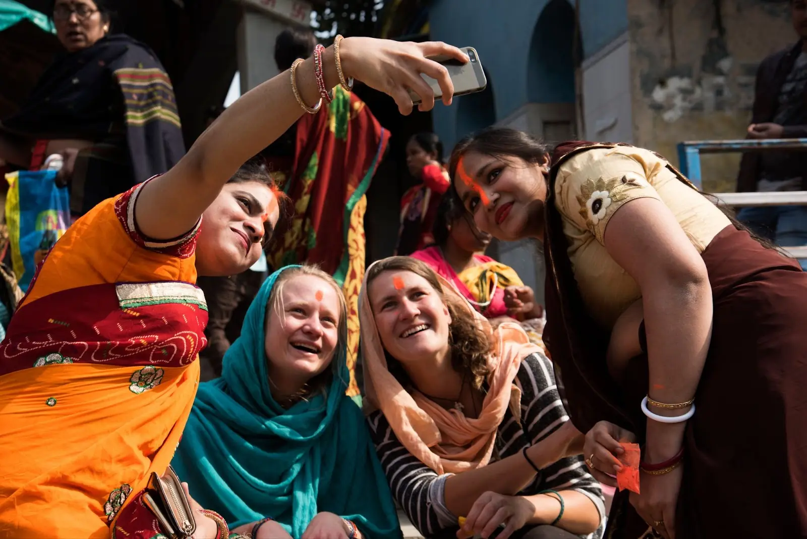 Happy tourists having photos taken with locals