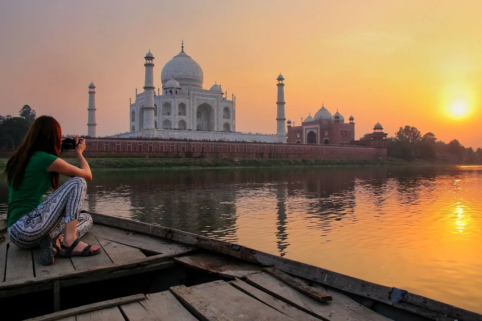 women looking at the taj mahal at sunset