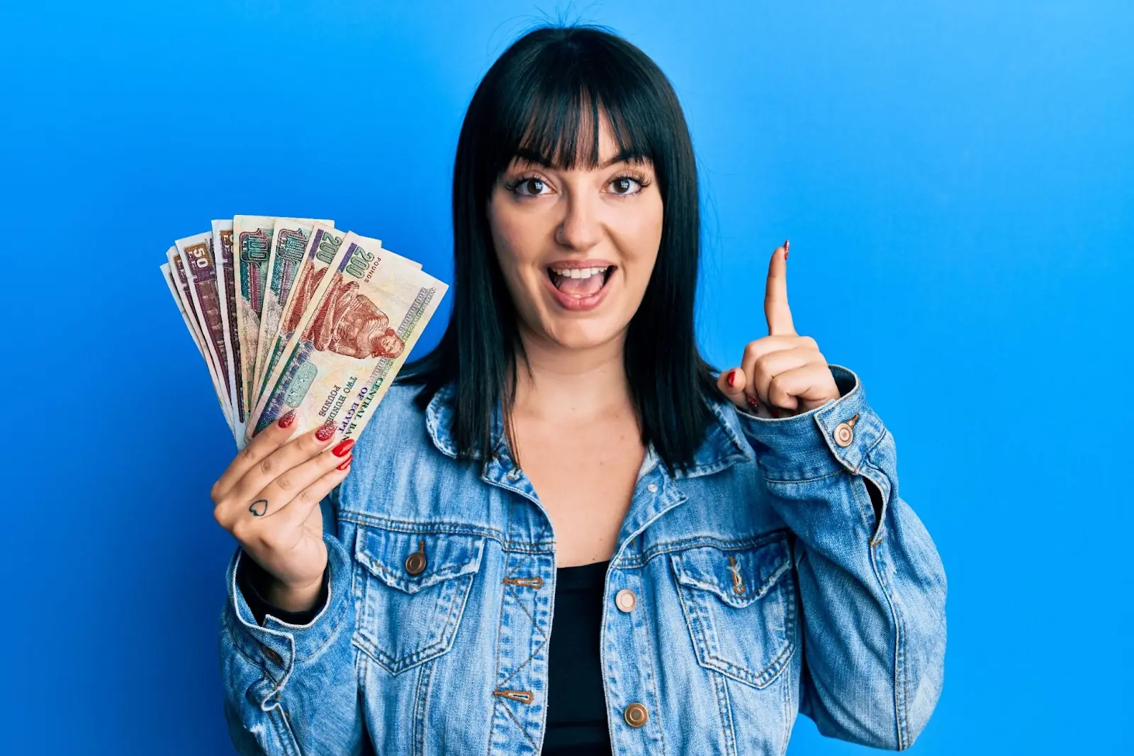 happy woman showing off her travel money