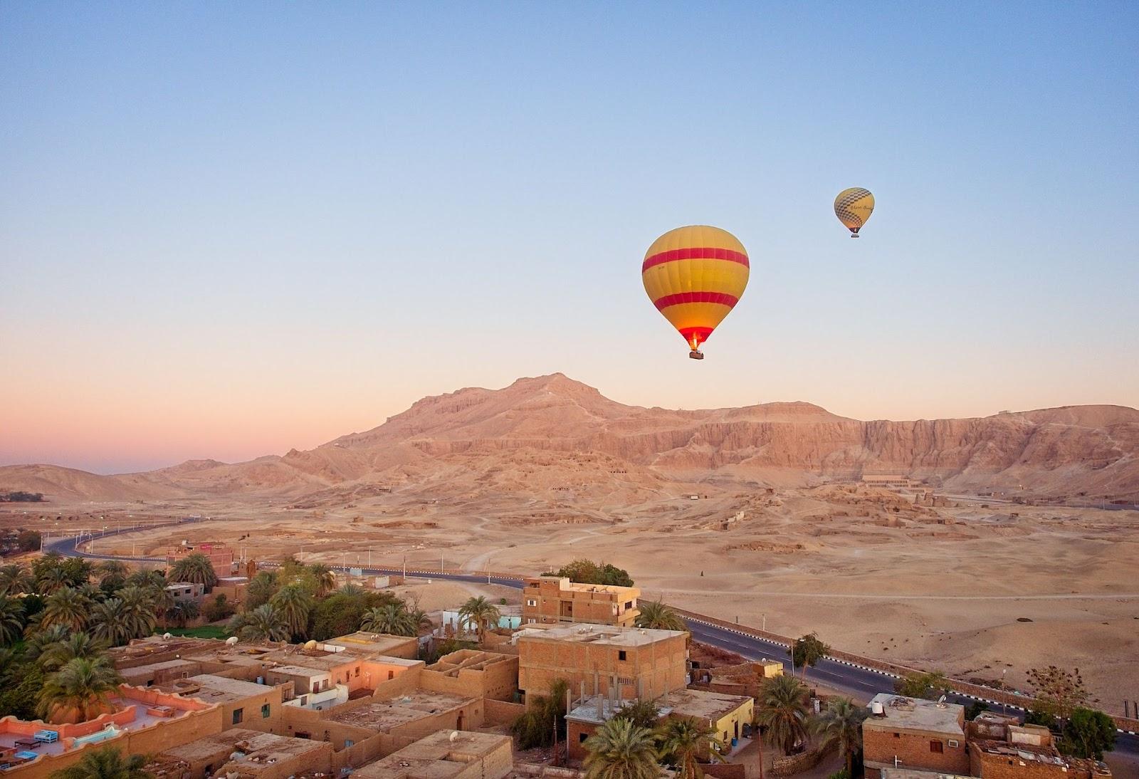 Hot air balloons over the city of Luxor paid for with foreign currency.