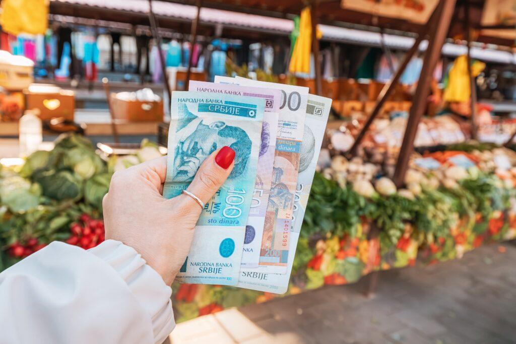 Serbian dinar notes in the hands of someone whopping at the market