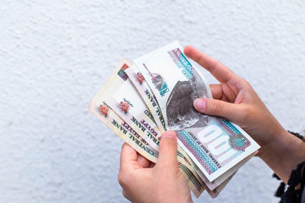 Woman counting Egyptian pounds