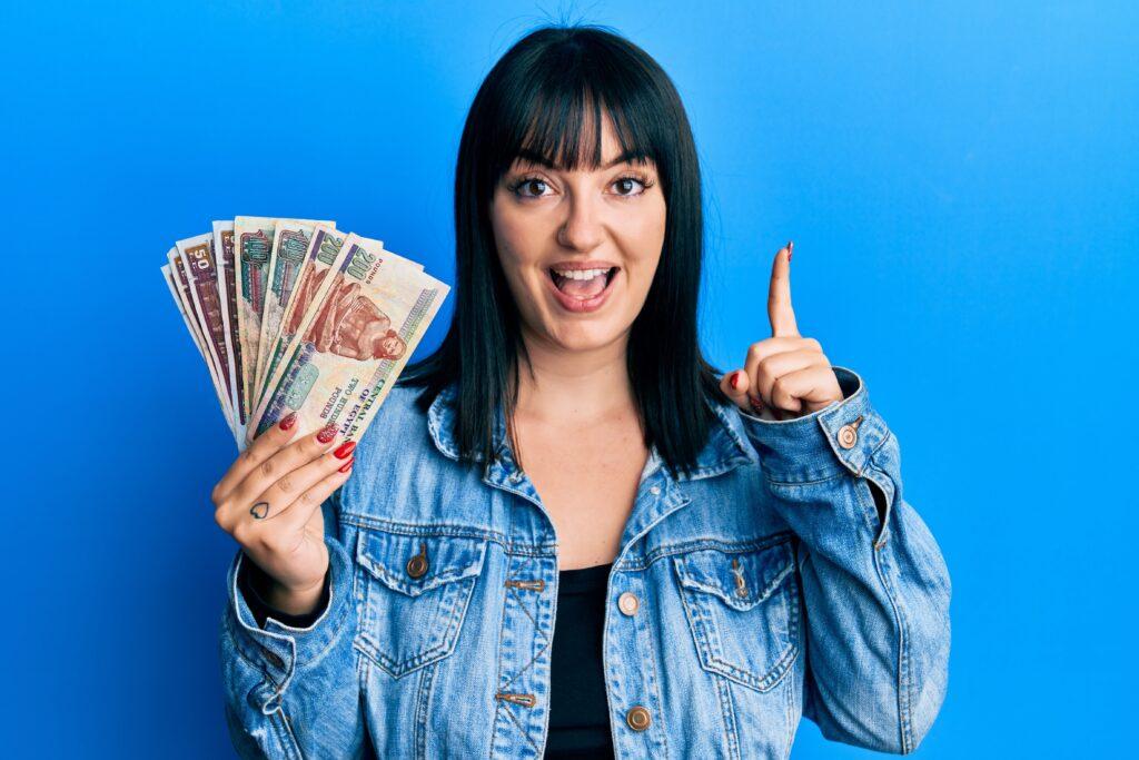 Young woman holding egyptian pounds