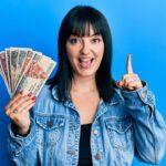 Young woman holding egyptian pounds