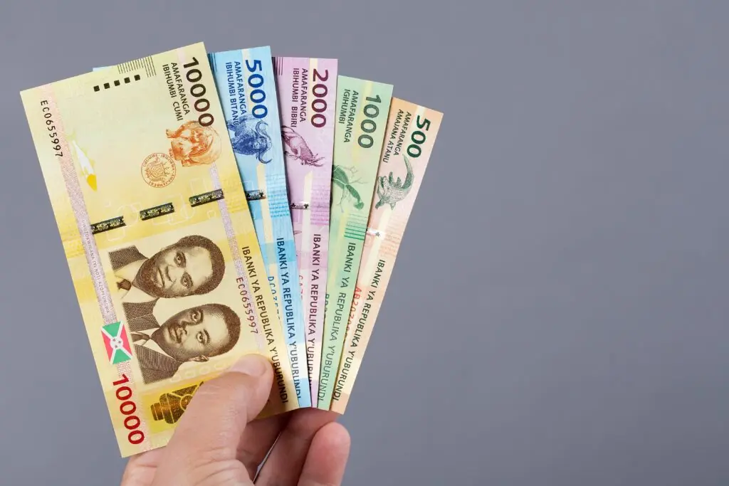 Burundian money - franc in the hand on a gray background