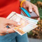 Woman holding Armenian banknotes