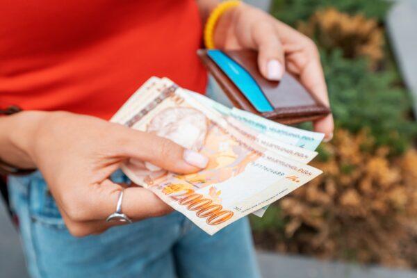 Woman holding Armenian banknotes