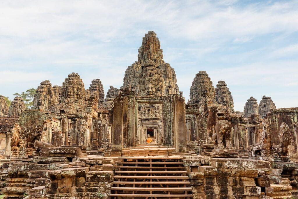 Mysterious ruins of ancient Bayon temple in Angkor Thom. Amazing Angkor Thom nestled among rainforest in Siem Reap, Cambodia. Enigmatic Angkor Thom is a popular tourist attraction